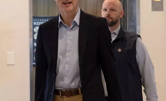 Canada Prime Minister Justin Trudeau briefly speaks to media as he walks through the lobby of the Delta Hotel by Marriott, Saturday, Nov. 30, 2024, in West Palm Beach, Fla. (AP Photo/Carolyn Kaster)