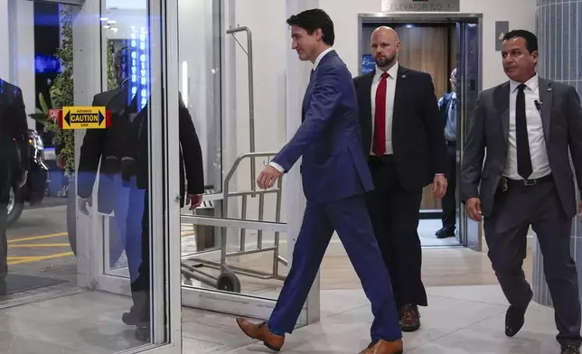 Canadian Prime Minister Justin Trudeau walks through the lobby of the Delta Hotel by Marriott, Friday, Nov. 29, 2024, in West Palm Beach, Fla. (AP Photo/Carolyn Kaster)