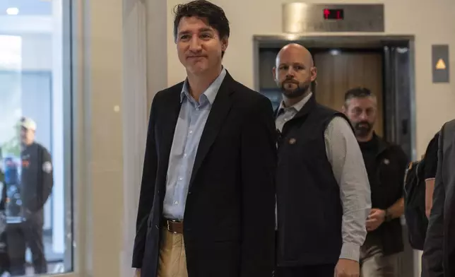 Canada Prime Minister Justin Trudeau walks through the lobby of the Delta Hotel by Marriott, Saturday, Nov. 30, 2024, in West Palm Beach, Fla. (AP Photo/Carolyn Kaster)