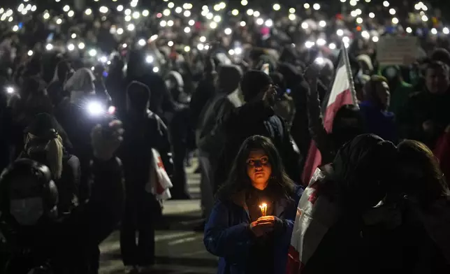 Demonstrators gather to protest against the government's decision to suspend negotiations on joining the European Union, in Tbilisi, Georgia, on Wednesday, Dec. 4, 2024. (AP Photo/Pavel Bednyakov)