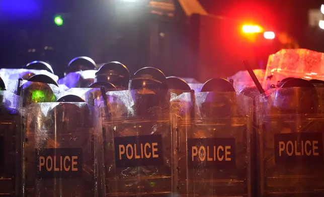 Police block demonstrators outside the parliament during a protest against the government's decision to suspend negotiations on joining the European Union in Tbilisi, Georgia, Tuesday, Dec. 3, 2024. (AP Photo/Pavel Bednyakov)