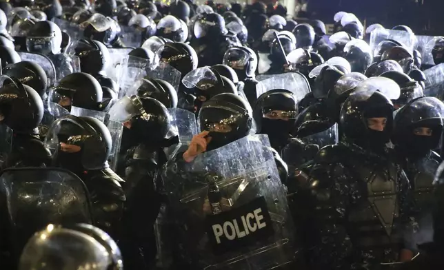 Police block demonstrators outside the parliament during a protest against the government's decision to suspend negotiations on joining the European Union in Tbilisi, Georgia, Tuesday, Dec. 3, 2024. (AP Photo/Zurab Tsertsvadze)