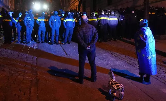 Police block demonstrators during a rally outside the parliament to protest the government's decision to suspend negotiations on joining the European Union in Tbilisi, Georgia, on Wednesday, Dec. 4, 2024. (AP Photo/Pavel Bednyakov)