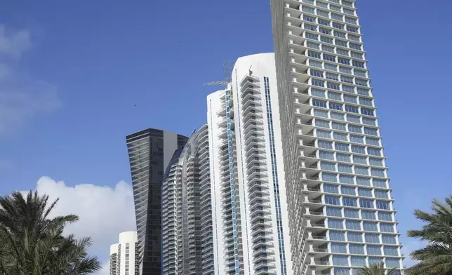 High-rise buildings are shown along Collins Avenue in Sunny Isles Beach, Fla., Tuesday, Dec. 17, 2024. (AP Photo/Lynne Sladky)