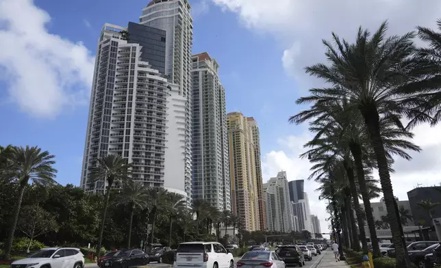 The Trump International, left, is shown along Collins Avenue in Sunny Isles Beach, Fla., Tuesday, Dec. 17, 2024. (AP Photo/Lynne Sladky)