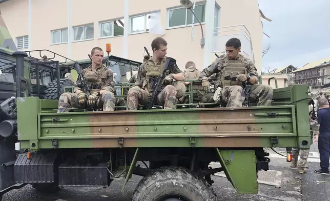 This photo provided Sunday Dec.15, 2024 by the French Army shows soldiers patrolling in a military truck in the French territory of Mayotte in the Indian Ocean, after Cyclone Chido caused extensive damage with reports of several fatalities. (Etat Major des Armées via AP)