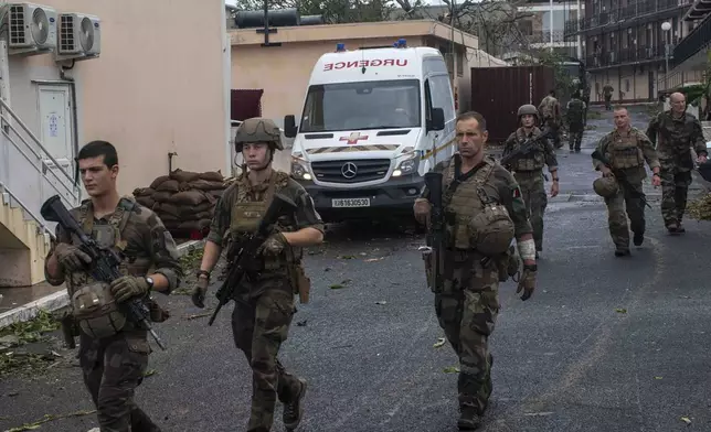 This photo provided Sunday Dec.15, 2024 by the French Army shows soldiers patrolling in the French territory of Mayotte in the Indian Ocean, after Cyclone Chido caused extensive damage with reports of several fatalities. (Etat Major des Armées via AP)