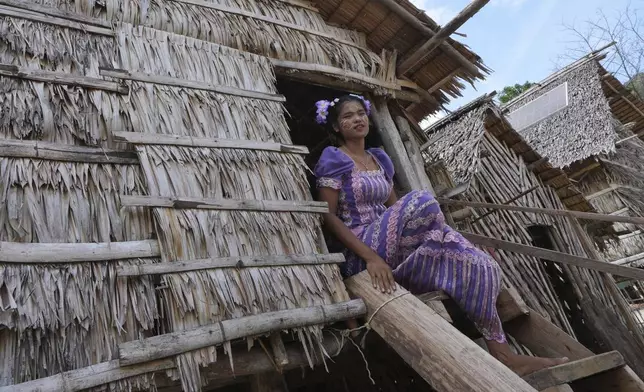 Loba Klathale sits on her house in Moken village at Surin Islands in Phang Nga Province, Thailand, Wednesday, Dec. 11, 2024. (AP Photo/Sakchai Lalit)