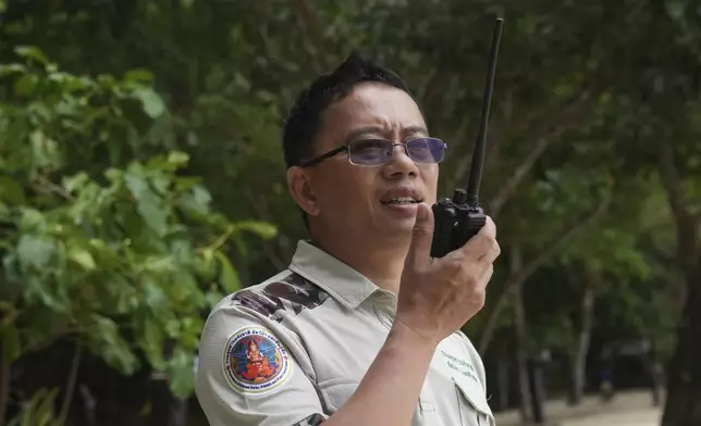 Chief of Surin national park Kriengkrai Pohcharoen speaks on walkie-talkie to his staff at Surin Islands in Phang Nga Province, Thailand, Friday, Dec. 13, 2024. (AP Photo/Sakchai Lalit)