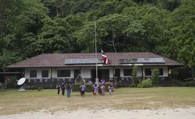 Moken students sing Thailand's national anthem at a learning center at Surin Islands in Phang Nga Province, Thailand, Thursday, Dec. 12, 2024. (AP Photo/Sakchai Lalit)