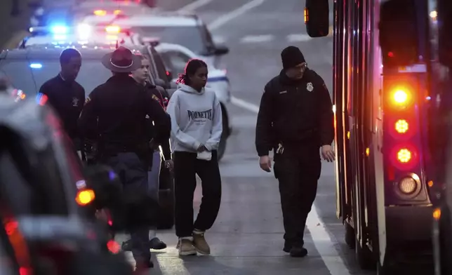 Students aboard a bus as they leave the shelter following a shooting at the Abundant Life Christian School, Monday, Dec. 16, 2024. (AP Photo/Morry Gash)