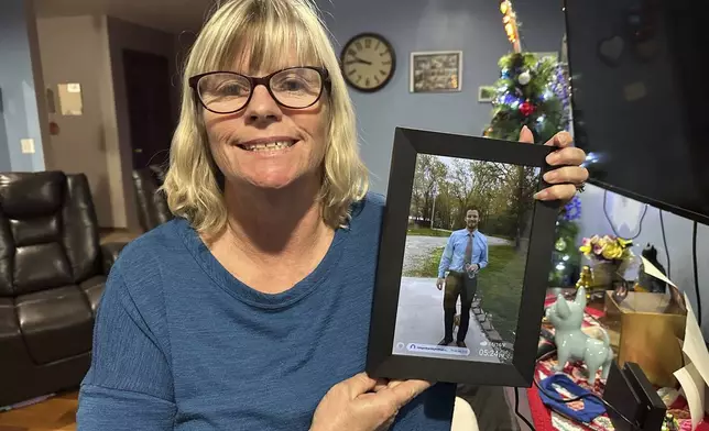 Stacey Collins Gardiner holds a picture of her son, Travis Timmerman, in her home in Urbana, Mo., Thursday, Dec. 12, 2024. Timmerman, an American citizen, was found outside Damascus, Syria, after having been imprisoned for months after crossing from Lebanon into Syria on a Christian pilgrimage. (AP Photo/Nick Ingram)