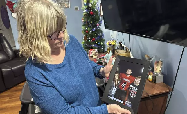 Stacey Collins Gardiner holds a picture of her son, Travis Timmerman, in her home in Urbana, Mo., Thursday, Dec. 12, 2024. Timmerman, an American citizen, was found outside Damascus, Syria, and had been imprisoned for months after crossing from Lebanon into Syria on a Christian pilgrimage. (AP Photo/Nick Ingram)