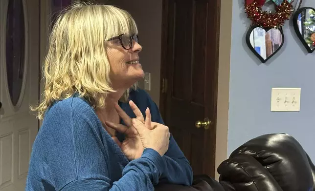 Stacey Collins Gardiner reacts to seeing her son, Travis Timmerman, on the news Thursday, Dec. 12, 2024, in her home in Urbana, Mo. Timmerman, an American citizen, was found outside Damascus, Syria, and had been imprisoned for months after crossing from Lebanon into Syria on a Christian pilgrimage. (AP Photo/Nick Ingram)