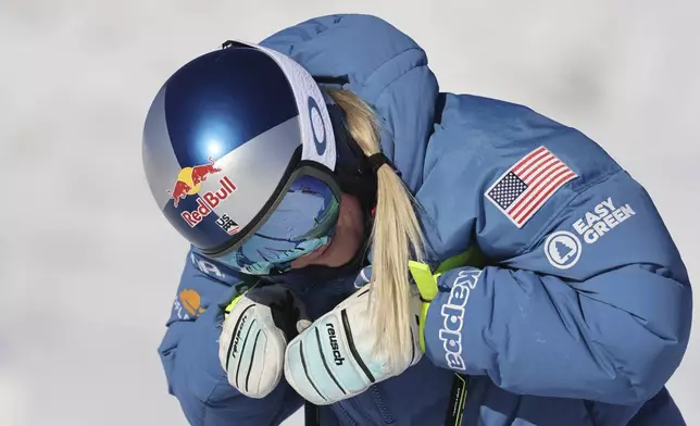 United States' Lindsey Vonn concentrates during the course inspection before competing in an alpine ski, women's World Cup super G, in St. Moritz, Switzerland, Saturday, Dec. 21, 2024. (AP Photo/Marco Trovati)