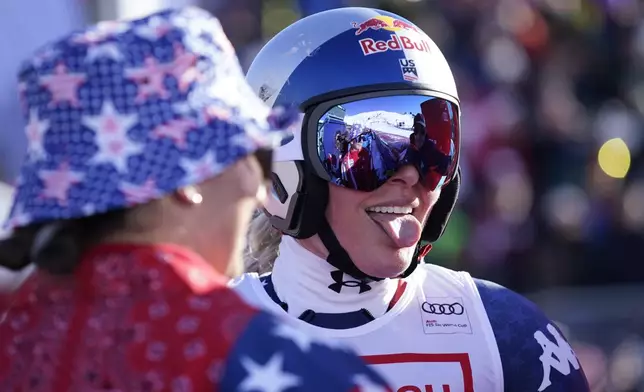 United States' Lindsey Vonn celebrates at the finish area of an alpine ski, women's World Cup super G, in St. Moritz, Switzerland, Saturday, Dec. 21, 2024. (AP Photo/Giovanni Auletta)