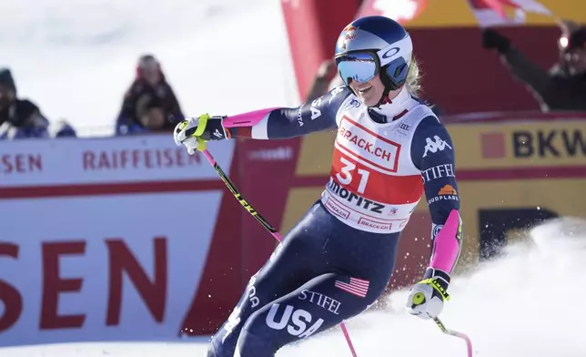 United States' Lindsey Vonn celebrates at the finish area of an alpine ski, women's World Cup super G, in St. Moritz, Switzerland, Saturday, Dec. 21, 2024. (AP Photo/Giovanni Auletta)