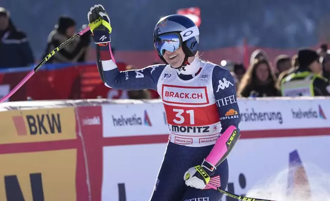 United States' Lindsey Vonn celebrates at the finish area of an alpine ski, women's World Cup super G, in St. Moritz, Switzerland, Saturday, Dec. 21, 2024. (AP Photo/Giovanni Auletta)