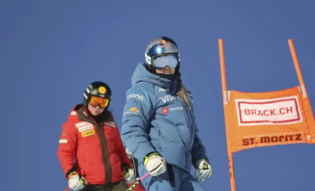 United States' Lindsey Vonn does a course inspection before competing in an alpine ski, women's World Cup super G, in St. Moritz, Switzerland, Saturday, Dec. 21, 2024. (AP Photo/Marco Trovati)