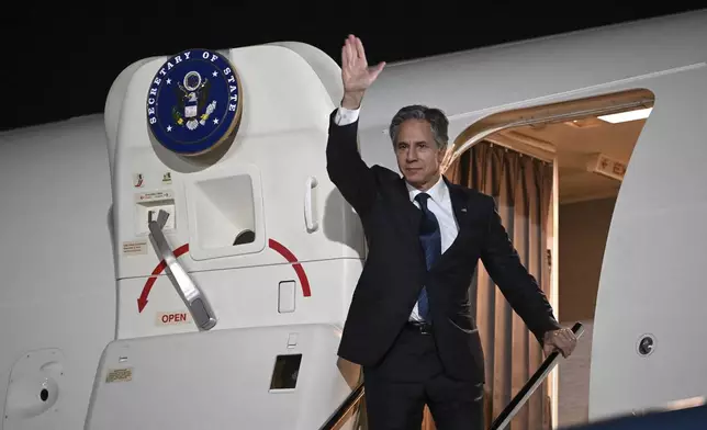 US Secretary of State Antony Blinken waves farewell as he boards his plane in Aqaba, Jordan, on Saturday, Dec. 14, 2024. (Andrew Caballero-Reynolds/Pool Photo via AP)