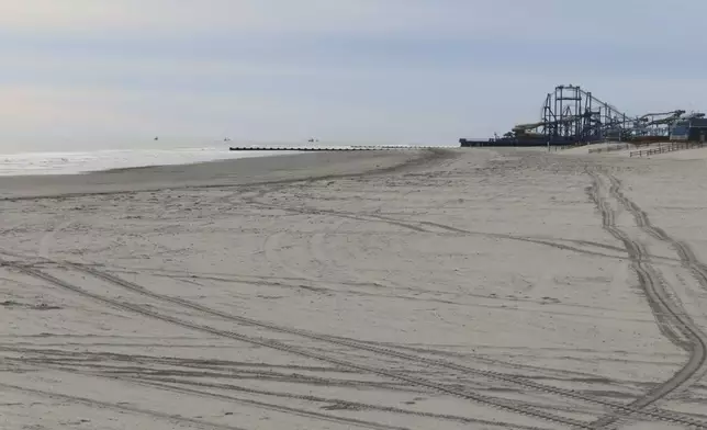 Amusement rides in neighboring Wildwood are visible from this recently widened beach in North Wildwood N.J. on Nov. 27, 2024, days before the city was to approve an agreement ending a decade-long battle with the state over the condition of the city's beaches. (AP Photo/Wayne Parry)