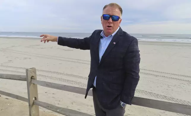 Mayor Patrick Rosenello points to the recently widened beach in North Wildwood, N.J. on Nov. 27, 2024, days before the city was to approve an agreement ending a decade-long battle with the state over the condition of the city's beaches. (AP Photo/Wayne Parry)