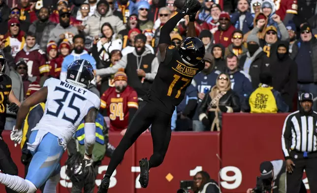 Washington Commanders wide receiver Terry McLaurin (17) catches a pass for a touchdown over Tennessee Titans cornerback Daryl Worley (35) during the first half of an NFL football game Sunday, Dec. 1, 2024, in Landover, Md. (AP Photo/Steve Ruark)