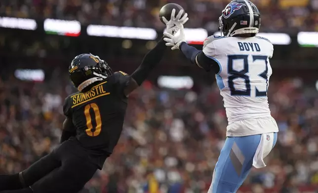 Washington Commanders cornerback Mike Sainristil (0) breaks up a pass intended for Tennessee Titans wide receiver Tyler Boyd (83) on a two-point conversion play during the second half of an NFL football game Sunday, Dec. 1, 2024, in Landover, Md. (AP Photo/Matt Slocum)