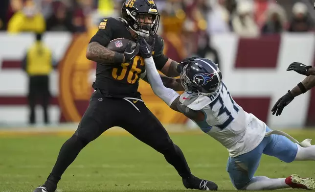 Washington Commanders running back Chris Rodriguez Jr. (36) runs the ball past Tennessee Titans safety Amani Hooker (37) during the second half of an NFL football game Sunday, Dec. 1, 2024, in Landover, Md. (AP Photo/Matt Slocum)