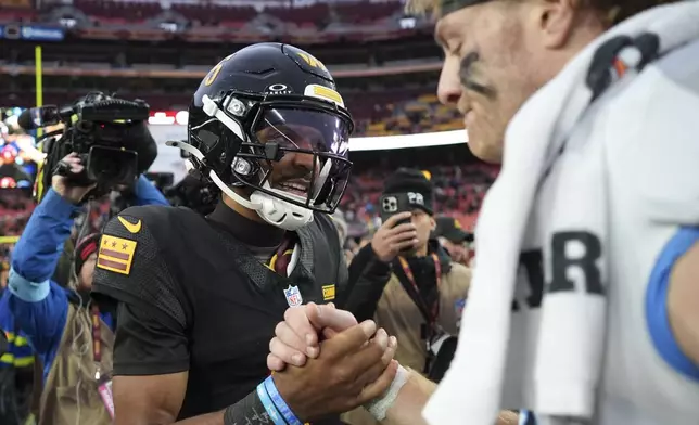 Washington Commanders quarterback Jayden Daniels, left, shakes hands with Tennessee Titans quarterback Will Levis, right, after an NFL football game Sunday, Dec. 1, 2024, in Landover, Md. The Commanders won 42-19. (AP Photo/Matt Slocum)