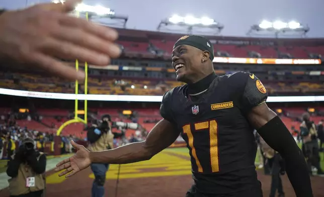 Washington Commanders wide receiver Terry McLaurin (17) celebrates the team's 42-19 win against the Tennessee Titans in an NFL football game Sunday, Dec. 1, 2024, in Landover, Md. (AP Photo/Matt Slocum)