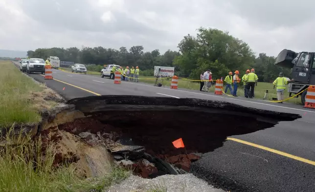 FILE - TDOT workers assess damage done by a sinkhole on eastbound Interstate 24 near Grundy County Tuesday May 18, 2010 near Chattanooga, Tenn. (Danielle Moore/Chattanooga Times Free Press via AP, File)