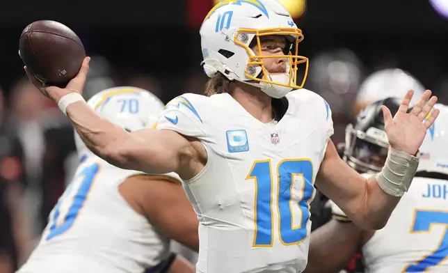 Los Angeles Chargers quarterback Justin Herbert (10) sets back to pass the ball during the second half of an NFL football game against the Atlanta Falcons on Sunday, Dec. 1, 2024 in Atlanta. (AP Photo/John Bazemore)