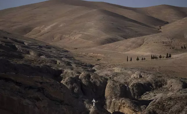 A statue of the Saint Charbel stands on the top of a cliff in Maaloula, a village where Aramaic is still spoken, located some 60 km northern Damascus, Syria, Wednesday, Dec. 25, 2024. (AP Photo/Leo Correa)