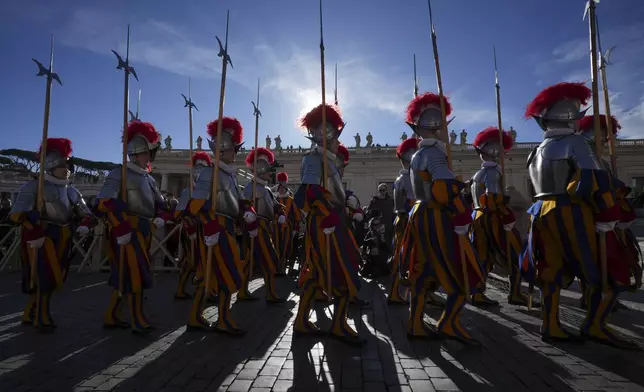 Swiss Guards march in front of St. Peter's Basilica at the Vatican, Wednesday, Dec. 25, 2024. (AP Photo/Andrew Medichini)