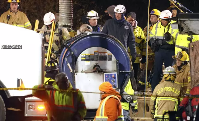 Rescue workers search in a sinkhole for Elizabeth Pollard, who disappeared while looking for her cat, in Marguerite, Pa., Tuesday, Dec. 3, 2024. (AP Photo/Gene J. Puskar)