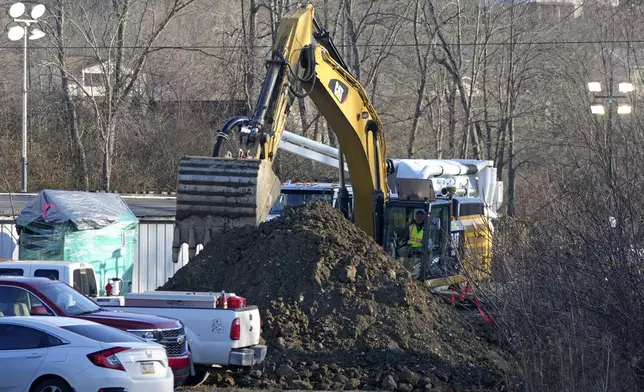 Rescue workers continue to search, Wednesday, Dec. 4, 2024, for Elizabeth Pollard, who is believed to have disappeared in a sinkhole while looking for her cat, in Marguerite, Pa. (AP Photo/Gene J. Puskar)