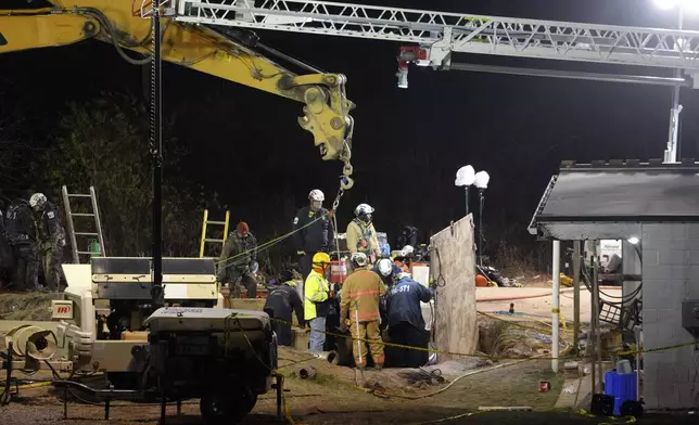 Rescue workers search through the night in a sinkhole for Elizabeth Pollard, who disappeared while looking for her cat, in Marguerite, Pa., Tuesday, Dec. 3, 2024. (AP Photo/Gene J. Puskar)