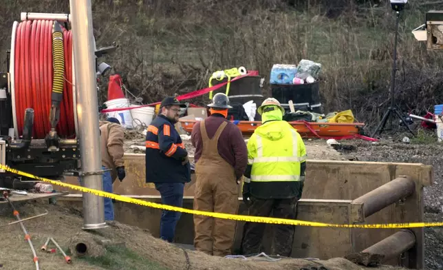 Rescue workers continue to search, Wednesday, Dec. 4, 2024, for Elizabeth Pollard, who is believed to have disappeared in a sinkhole while looking for her cat, in Marguerite, Pa. (AP Photo/Gene J. Puskar)