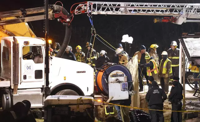 Rescue workers search in a sinkhole for Elizabeth Pollard, who disappeared while looking for her cat, in Marguerite, Pa., Tuesday, Dec. 3, 2024. (AP Photo/Gene J. Puskar)