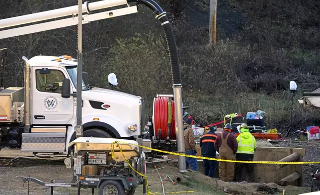 Rescue workers continue to search, Wednesday, Dec. 4, 2024, for Elizabeth Pollard, who is believed to have disappeared in a sinkhole while looking for her cat, in Marguerite, Pa. (AP Photo/Gene J. Puskar)