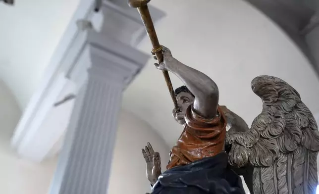 A statue of an angel rests in an elevated position at Old North Church, Wednesday, Dec. 18, 2024, in Boston. (AP Photo/Steven Senne)