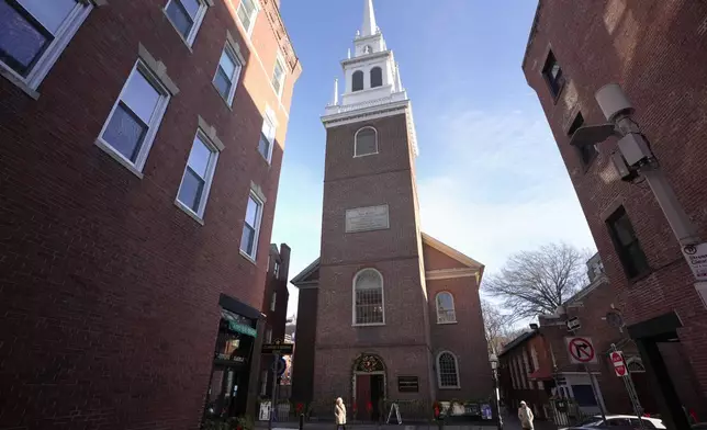 Passers-by walk near Old North Church, center, Wednesday, Dec. 18, 2024, in Boston. (AP Photo/Steven Senne)