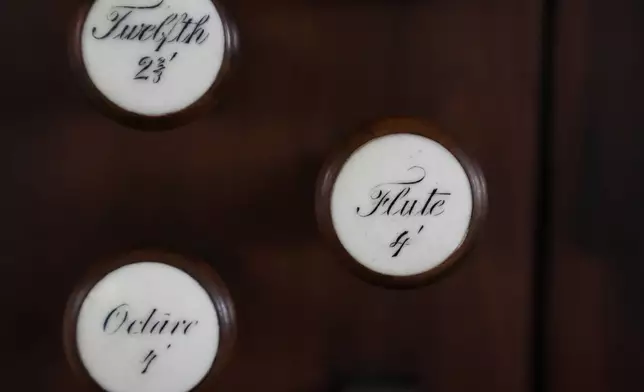 Knobs on an 18th century organ are attached to a wood panel at Old North Church, Wednesday, Dec. 18, 2024, in Boston. (AP Photo/Steven Senne)