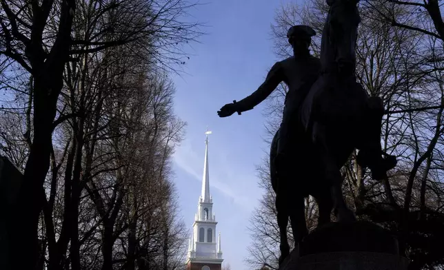 A statue of Paul Revere, right, stands in front of Old North Church, behind, Wednesday, Dec. 18, 2024, in Boston. (AP Photo/Steven Senne)