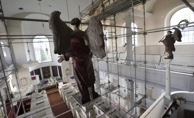 Statues of angels rest in an elevated positions at Old North Church, Wednesday, Dec. 18, 2024, in Boston. (AP Photo/Steven Senne)