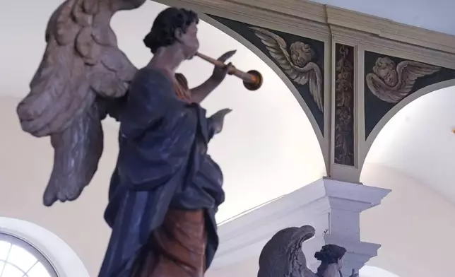 Recently restored, nearly 300-year-old painted angels, at top right, adorn an arch at the historic Old North Church in the North End neighborhood, Friday, Dec. 20, 2024, in Boston. (AP Photo/Charles Krupa)