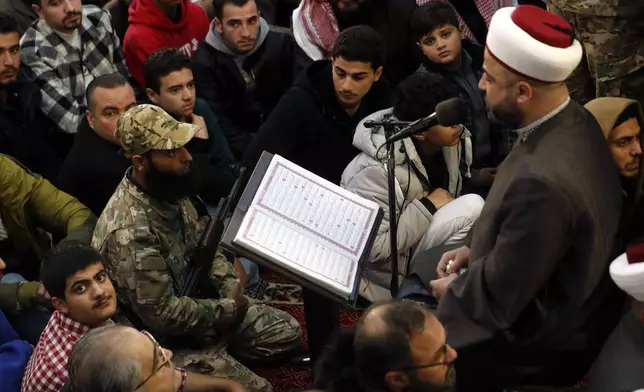 Syrians listen a Muslim cleric as they attend Friday prayers inside the 7th century Umayyad Mosque in Damascus, Syria, Friday, Dec. 13, 2024. (AP Photo/Omar Sanadiki)