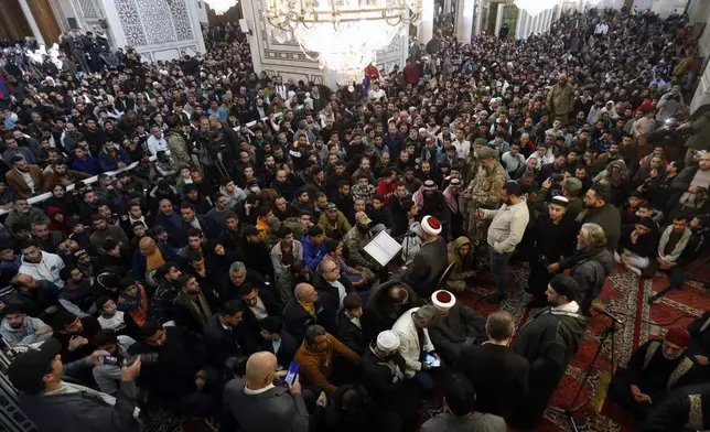 Syrians attend Friday prayers inside the 7th century Umayyad Mosque in Damascus, Syria, Friday, Dec. 13, 2024. (AP Photo/Omar Sanadiki)