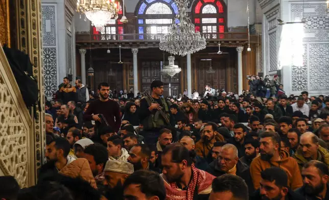 Syrians perform Friday prayers inside the 7th century Umayyad Mosque in Damascus, Syria, Friday, Dec. 13, 2024. (AP Photo/Omar Sanadiki)